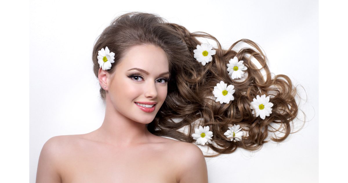 smiling-woman-with-beautiful-long-hair-wna-flowers-it-white